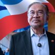 Perdana Menteri Malaysia Datuk Seri Anwar Ibrahim berdiri di hadapan latar bendera Sabah, melambangkan komitmen Kerajaan MADANI terhadap MA63 dan peningkatan Pemberian Khas Sabah.