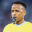 Omar Artan meniup wisel ketika mengadili perlawanan bola sepak antarabangsa